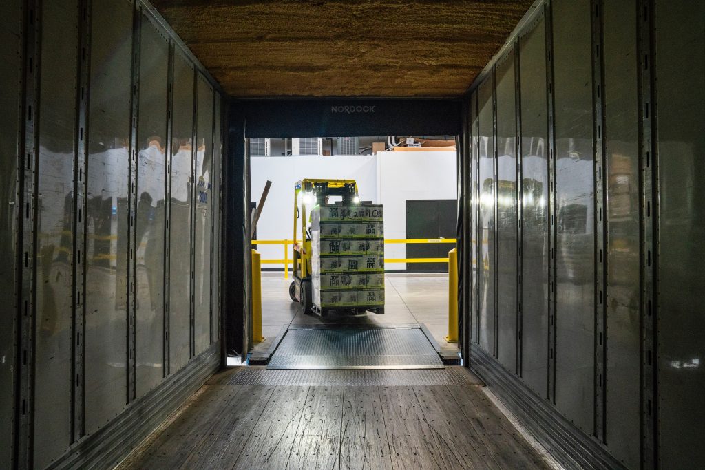 A pallet being loaded into a shipping container