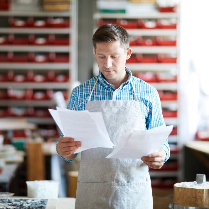 small business paperwork Small businessperson looking at paperwork
